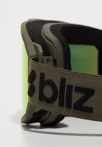 Skibriller med grøn linse og olivengrøn strop. Har et struktureret tekstilbånd med "bliz" logo, tyk skumpolstring for komfort.