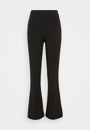 Black flared pants made of stretch fabric. Features a high waistband, smooth texture, and vertical seam detailing along the front.