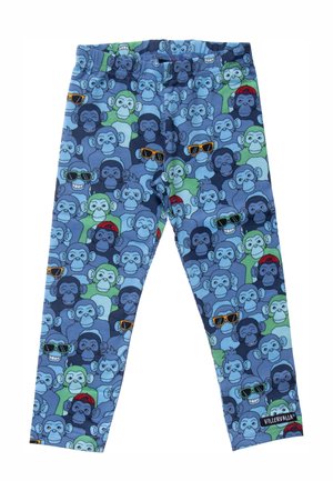 Leggings infantiles con un patrón colorido de monos de dibujos animados que llevan gafas de sol, sombreros y mascarillas, sobre un fondo azul y verde.