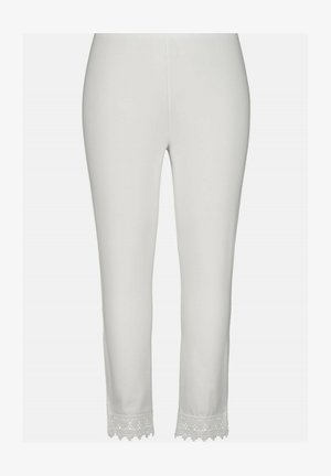 Witte leggings van zachte stof. Beschikt over een kantafwerking aan de onderrand met een golvend ontwerp. Elastiche tailleband voor comfort.