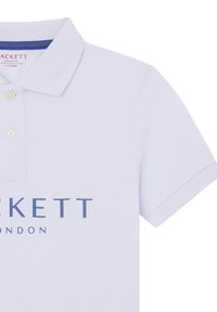 Camisa polo blanca de algodón, con un cuello estándar, dos botones y un logo gráfico en azul oscuro que dice "PACKETT LONDON."