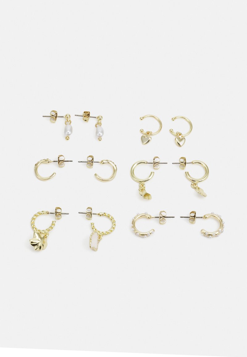 Nine pairs of gold-tone earrings including studs, hoops, and charms with various designs, featuring pearls, hearts, and shell motifs.
