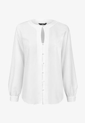 Biała bluzka z długim rękawem, okrągłym dekoltem, z przodu na guziki oraz z detalem w formie łezki. Miękki, gładki materiał z marszczonymi mankietami.