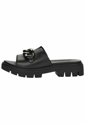 Black leather slide-on sandals featuring a wide strap and a decorative chain accent, with a chunky textured sole for grip.