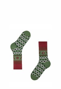 Stricksocken mit grüner Basis und roten Akzenten. Das Design umfasst ein geometrisches Muster mit weißen und schwarzen Details. Weiche Textur.