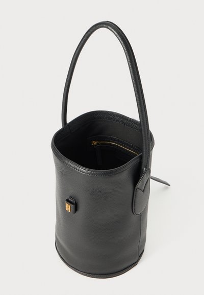 Black leather bucket bag with a smooth texture, rounded shape, and a single handle. Features a gold zipper pocket inside and a gold logo detail.