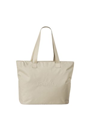Sac fourre-tout beige avec deux anses plates, fabriqué en nylon doux, avec le logo « Bench. » en relief sur le devant. Design simple.
