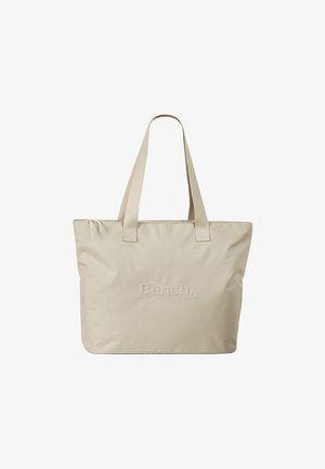 Sac fourre-tout beige avec deux anses plates, fabriqué en nylon doux, avec le logo « Bench. » en relief sur le devant. Design simple.