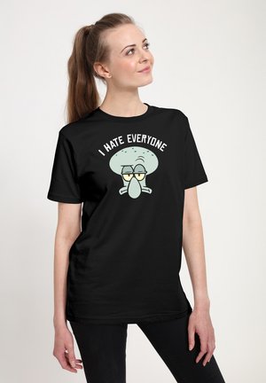 Black cotton t-shirt featuring a graphic of a light green cartoon character with glasses and the text "I HATE EVERYONE" above it.
