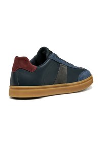 Baskets en cuir bleu foncé avec des accents en suède gris et bordeaux, dotées d'une semelle en caoutchouc gomme et d'un bout arrondi. Fermeture à lacets.