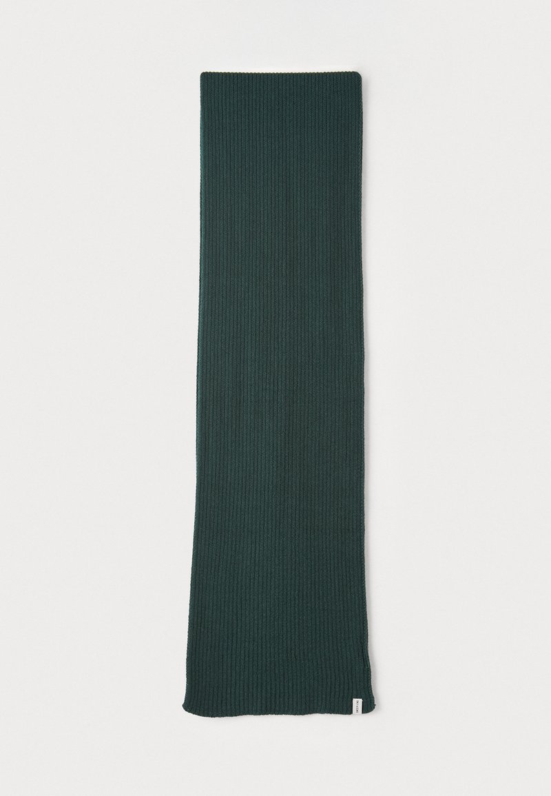 Ribbed dark green scarf, rectangular shape, lightweight texture, finished edges, with a small white label at one end.