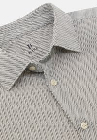 Camicia da uomo in tessuto bianco e nero con texture. Presenta un colletto a punta, due bottoni e un piccolo motivo geometrico su tutta la superficie.