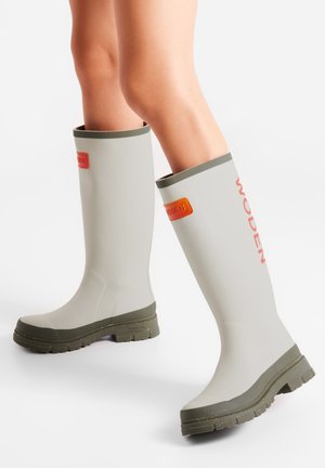 Gray rubber knee-high boots with green soles and trim. Features an orange WODEN logo patch on the side and a textured surface for grip.