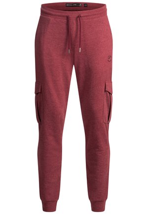 Rote, weiche Jogginghosen aus Stoff mit elastischem Bund und Kordelzug, seitlichen Cargo-Taschen und schmal zulaufenden Beinen. Markenlogo auf der Vorderseite.