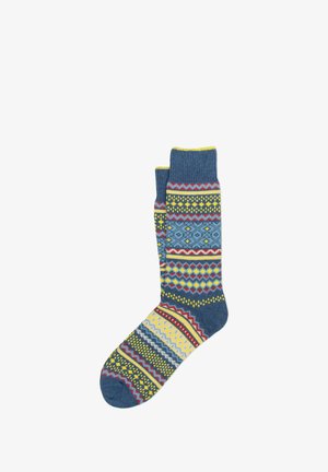 Calzini multicolori con base blu e motivi geometrici in giallo, rosso e bianco. Tessuto a maglia con polsini a coste.