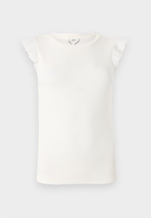 Valge ilma varrukateta topp soonilise tekstuuriga, millel on pitsist rippuvad aksessuaarid õlgadel ja ümmargune kaelus.