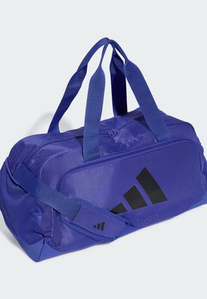 Borsa sportiva duffel in nylon blu con doppi manici, tracolla regolabile, scomparti con zip e logo Adidas nero sulla tasca frontale.