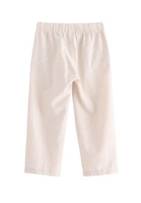 Culotte di un beige chiaro con una cintura elastica, realizzate in un tessuto morbido. Lunghezza cropped senza motivi aggiuntivi o dettagli hardware.