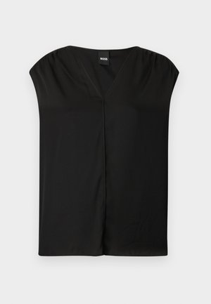 Blouse noire avec un décolleté en V, des manches courtes et évasées, et une coupe décontractée. Tissu lisse avec des coutures minimales et sans motifs visibles.