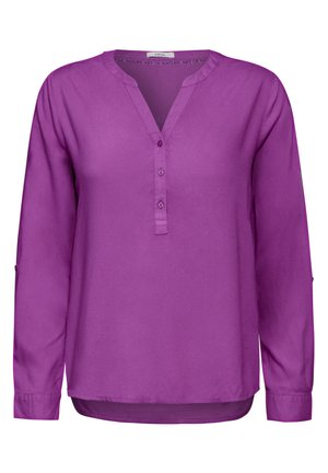 Blusa larga de manga larga en color púrpura con escote en V, placket de botones y mangas con vuelta. Tejido suave con un ajuste holgado y dobladillo curvado.