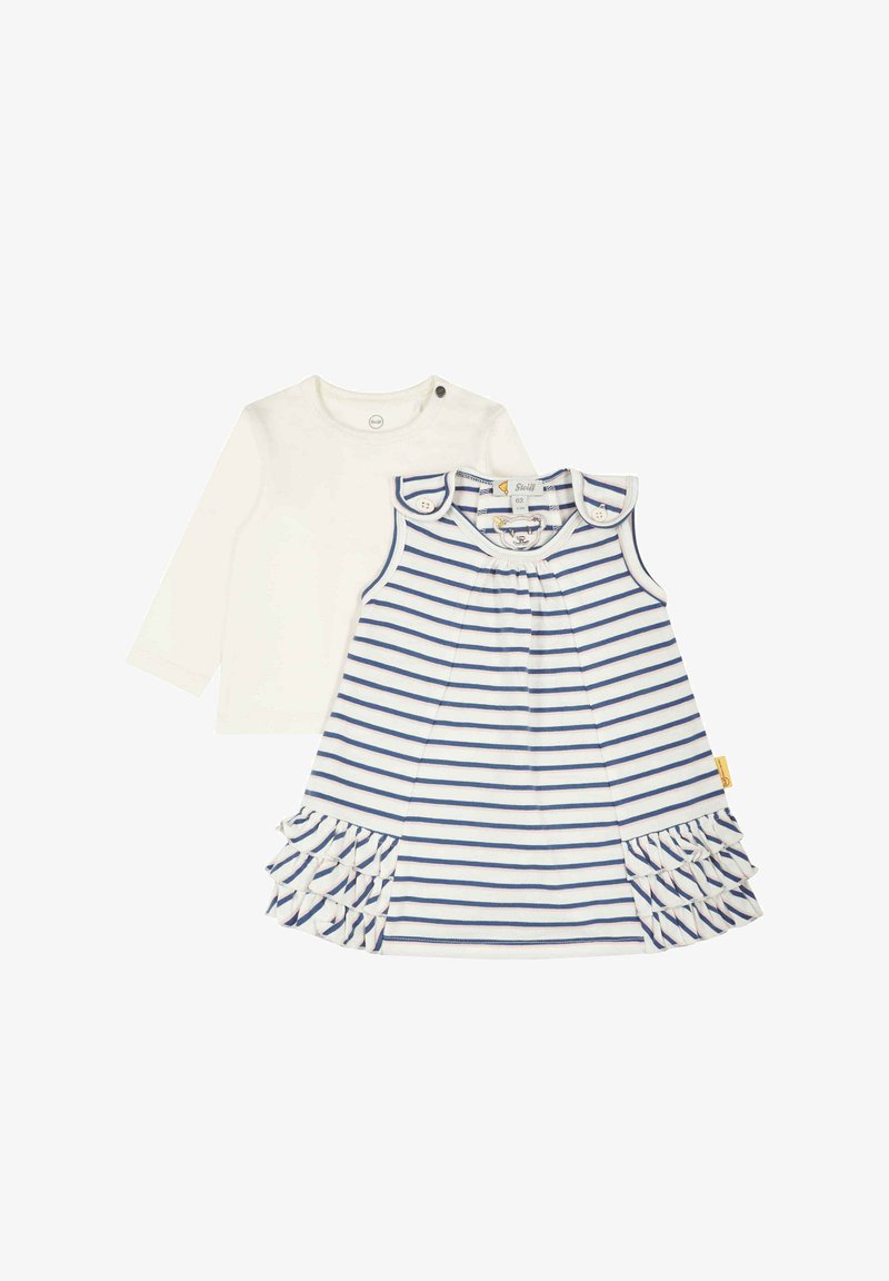 Dětský dvoudílný set: bílá halenka s dlouhým rukávem a patentkami na rameni, spolu s bezramínkovými pruhovanými šaty v modré a bílé barvě s volánkovým lemem.