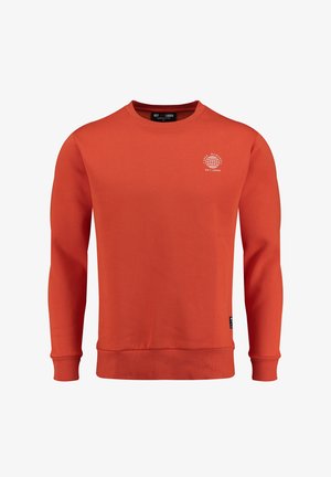 Pomarańczowy sweter wykonany z miękkiego materiału, z okrągłym dekoltem i ściągaczami na rękawach. Zawiera białą grafikę kuli na piersi.