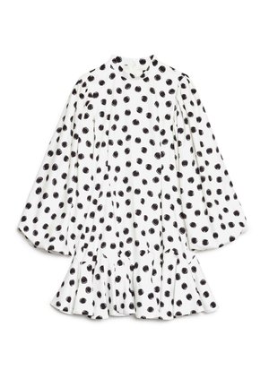 Robe blanche à pois noirs, col haut, manches longues bouffantes et ourlet évasé. Confectionnée dans un tissu léger à la texture lisse.