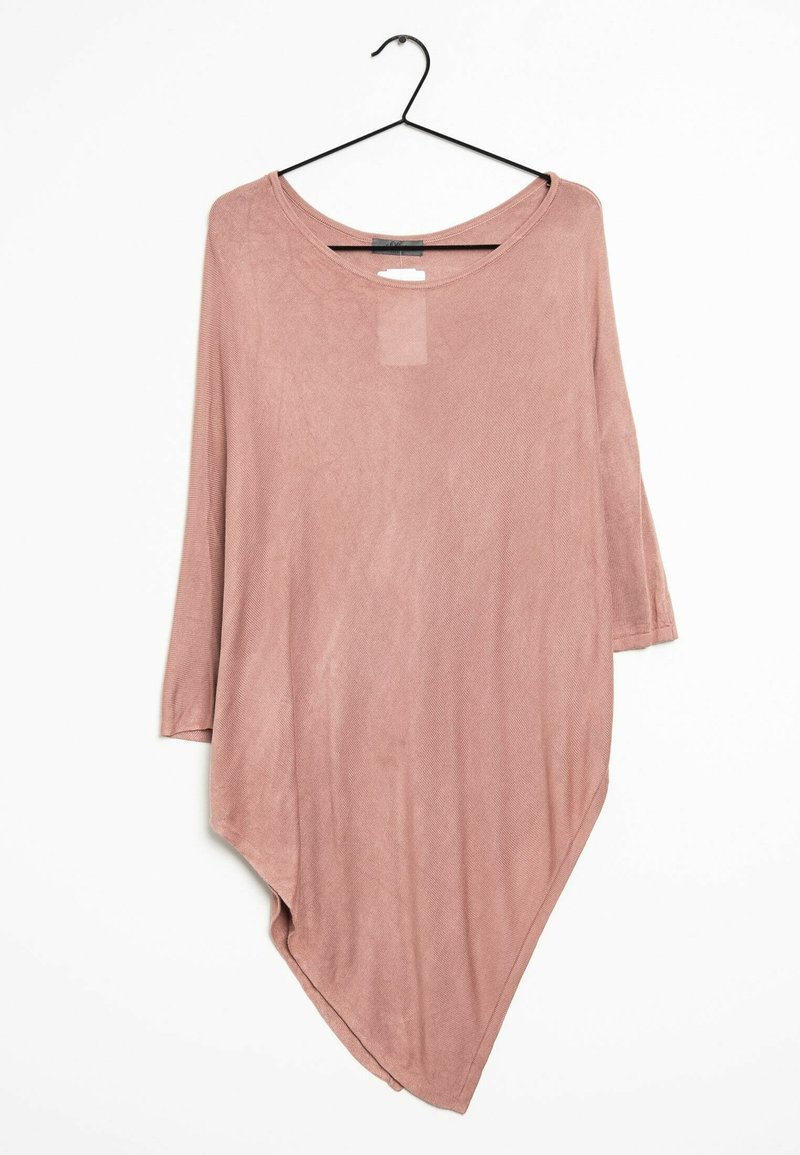 Haut asymétrique à manches longues mauve clair suspendu sur un cintre noir sur fond blanc, avec un col arrondi et un ourlet incliné.