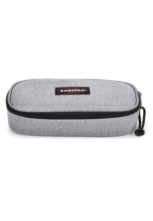 Gray fabric pencil case with a textured finish, black zipper, and a circular zipper pull, featuring an Eastpak logo patch on top.