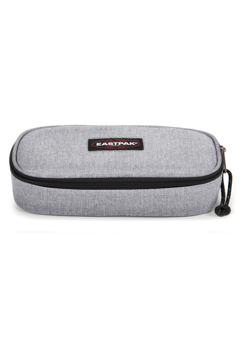 Gray fabric pencil case with a textured finish, black zipper, and a circular zipper pull, featuring an Eastpak logo patch on top.