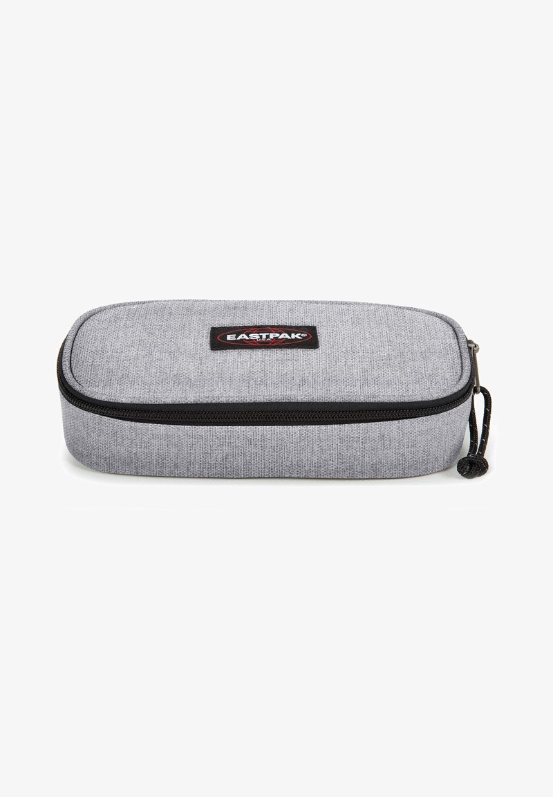 Gray fabric pencil case with a textured finish, black zipper, and a circular zipper pull, featuring an Eastpak logo patch on top.