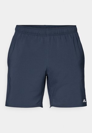 Námornícke modré športové šortky s elastickým pásom, bočnými vreckami a malým bielym logom v ľavom dolnom rohu. Hladká, ľahká látka.
