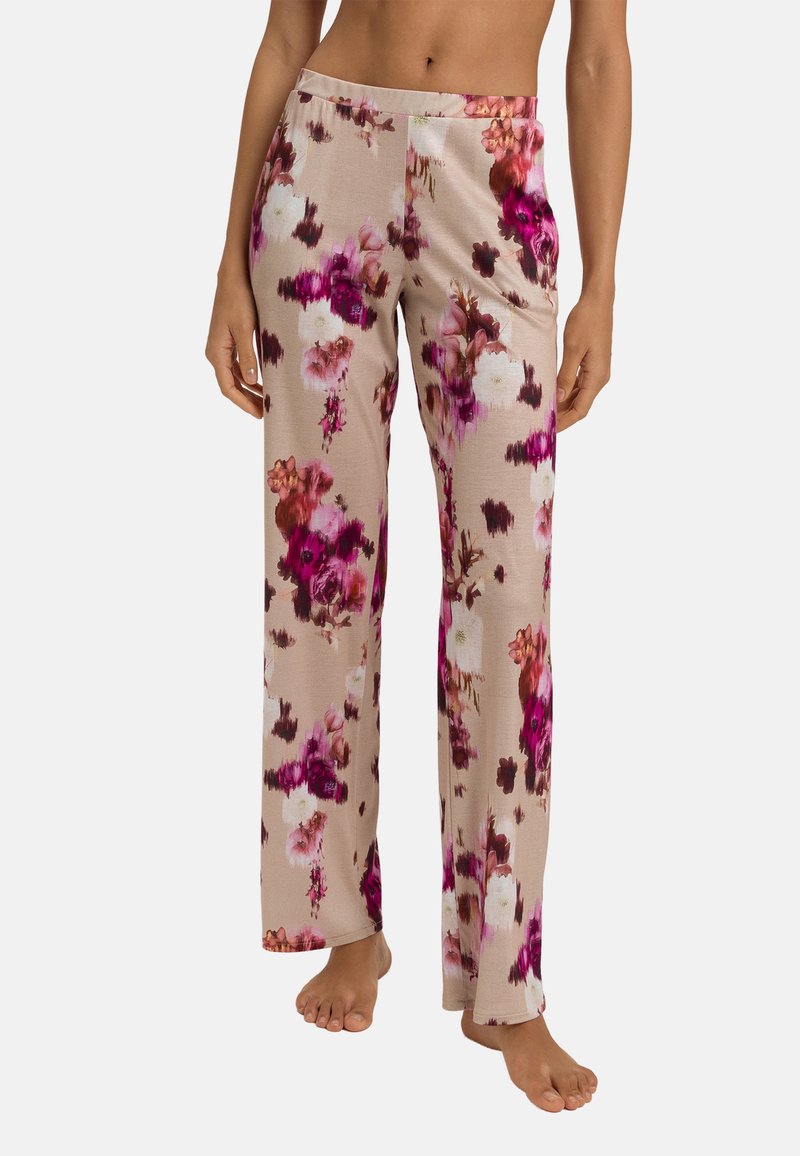 Lange pyjamabroek met een bloemenpatroon, gemaakt van zachte stof, in tinten roze en beige, met een losse pasvorm en wijde pijpen.