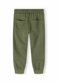 Groene sweatpants met een elastische tailleband, twee achterzakken, taps toelopende pijpen en geribbelde manchetten. Gladde textuur, casual ontwerp.