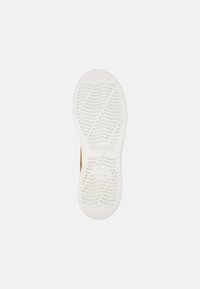 White rubber shoe sole with wavy tread pattern and "Camper" branding. Displays a smooth finish with a round toe and slight arch.