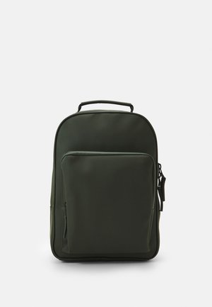 Dark green backpack made of smooth material; features a front pocket and top handle; minimalist design, rectangular shape.