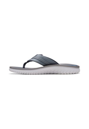 Sandale décontractée pour homme avec des brides en cuir bleu marine et une semelle blanche épaisse texturée, vue de profil sur fond blanc.