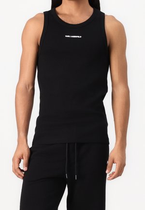 Débardeur sans manches noir en tissu doux, avec un col rond et un petit logo blanc "Karl Lagerfeld" sur la poitrine.