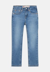Slim taper džínsy vyrobené zo svetlomodrého denimu, s piatimi vreckami, medenými súčiastkami a žltým prešívaním pozdĺž švov.