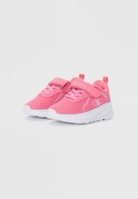 Pink athletic shoes with a mesh upper, white sole, and laces. Features include a back tab and logo detailing on the side.