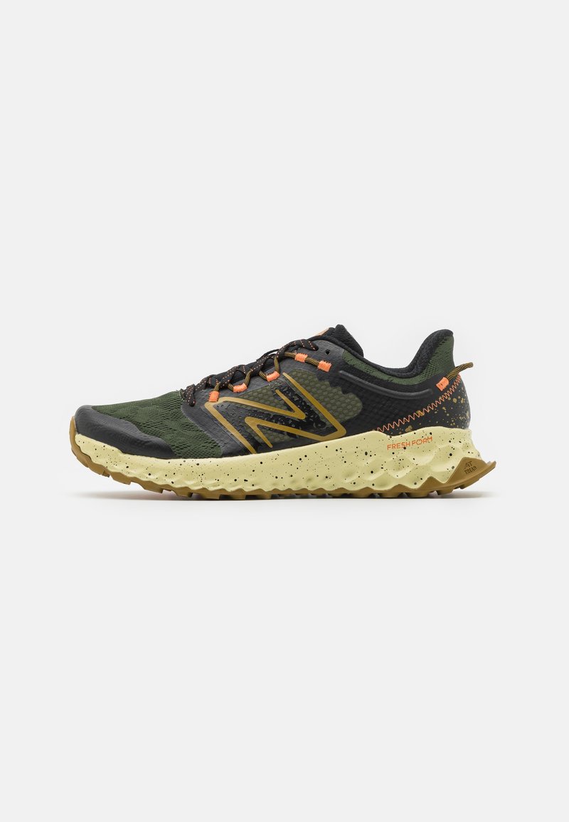 Trail running shoe featuring a dark green mesh upper with black accents, orange laces, and a textured yellow midsole with speckles.