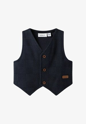 Granatowa kamizelka w kratę, wykonana z teksturowanej tkaniny, z dekoltem w kształcie litery V, trzema brązowymi guzikami oraz skórzaną metką w dolnym prawym rogu.