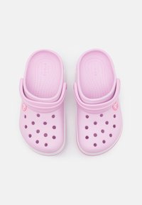 Růžové clogs typu Crocs s hladkou, lehkou texturou, vybavené několika ventilačními otvory a zadním popruhem pro bezpečné uchycení.