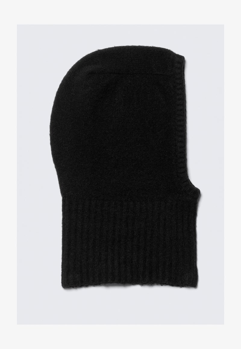 Black knitted beanie with a ribbed texture, slightly elongated at the top, made from soft material; features a seamless design.