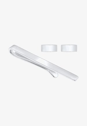 Silberner Metall-Krawattenclip mit einem schlanken, elongated Design und einer glatten Oberfläche, begleitet von zwei passenden Manschettenknöpfen in ähnlicher Farbe und Stil.