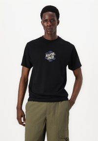 Tricou din bumbac negru cu imprimeu grafic ce prezintă "Santa Cruz" în litere multicolore. Mâneci scurte și guler rotund.