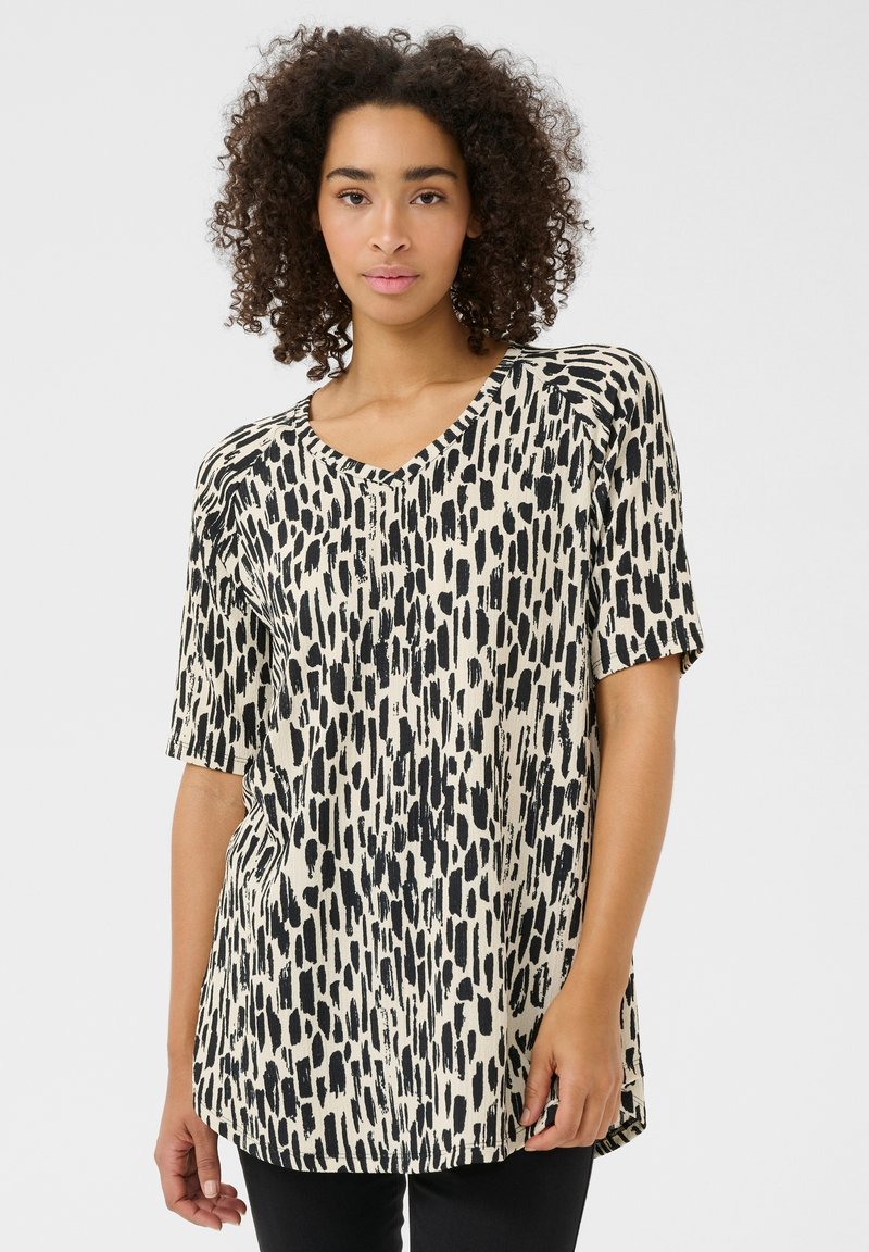 Top a manica corta con scollo a V in crema con stampa astratta nera. Vestibilità rilassata, tessuto morbido e orlo arrotondato. Adatto per un look informale.