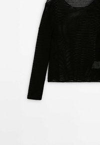 Black long-sleeve open-knit sweater with round neckline and visible mesh pattern on white background.