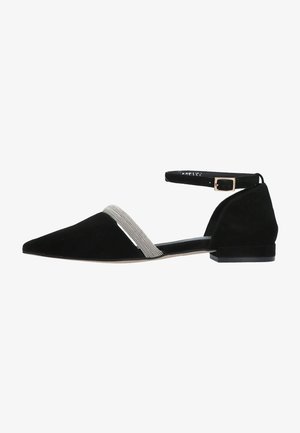 Black suede flat shoe with a pointed toe, ankle strap, and rhinestone embellishment across the front for added detail.