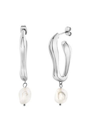 Orecchini a cerchio in argento presentano un design fluido e ondulato, con una perla barocca bianca sospesa nella parte inferiore, che aggiunge texture e contrasto.